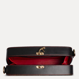 The Vintage Radio has a Stylised diagonal top edge clutch with a removable strap. Available at Paul Adams World